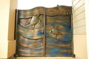 Wooden cabinet doors with carved bird designs and a wave-like pattern.
