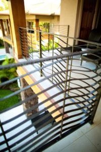 Curved metal railing with a modern design on a balcony.