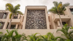 Intricate metal tree artwork on a building facade.
