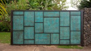 Decorative teal and black geometric metal gate with a modern design.