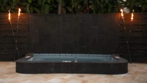 Elegant rectangular black fountain with water cascading down a smooth wall.