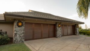 Modern house exterior with stone accents and wooden garage doors.