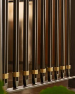 Close-up of polished organ pipes arranged in a row.