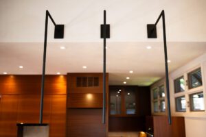 Modern bathroom with sleek black shower fixtures and warm wooden accents.