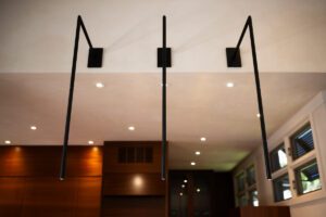 Modern glass shower enclosure with black fixtures and recessed lighting.
