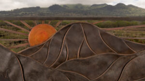 A Gate With Mountain Range With Sun Closeup View