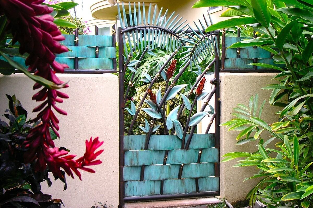 A garden gate adorned with vertical planter pockets filled with greenery.