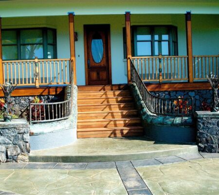 Front porch with wooden door and stone stairs.