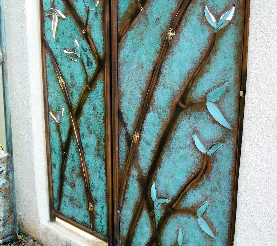 Decorative glass window with a nature-inspired tree and bird design.