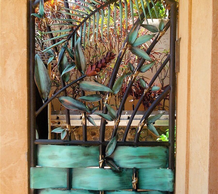 Artistic metal sculpture with green elements displayed indoors.
