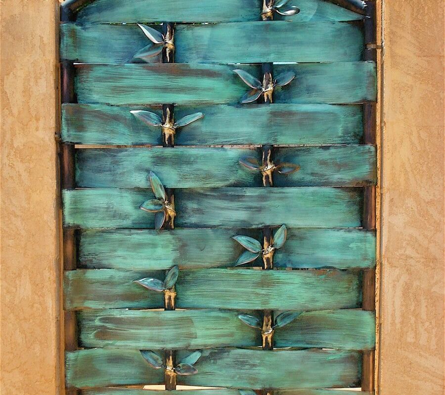 Close-up of turquoise beads woven on a wooden frame.