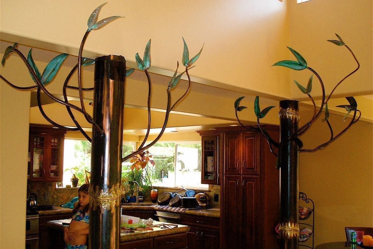 Decorative metal bird sculptures on tall stands in a cozy dining area.