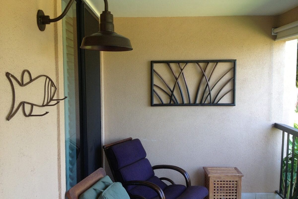 Cozy patio seating with purple chairs and decorative wall art.