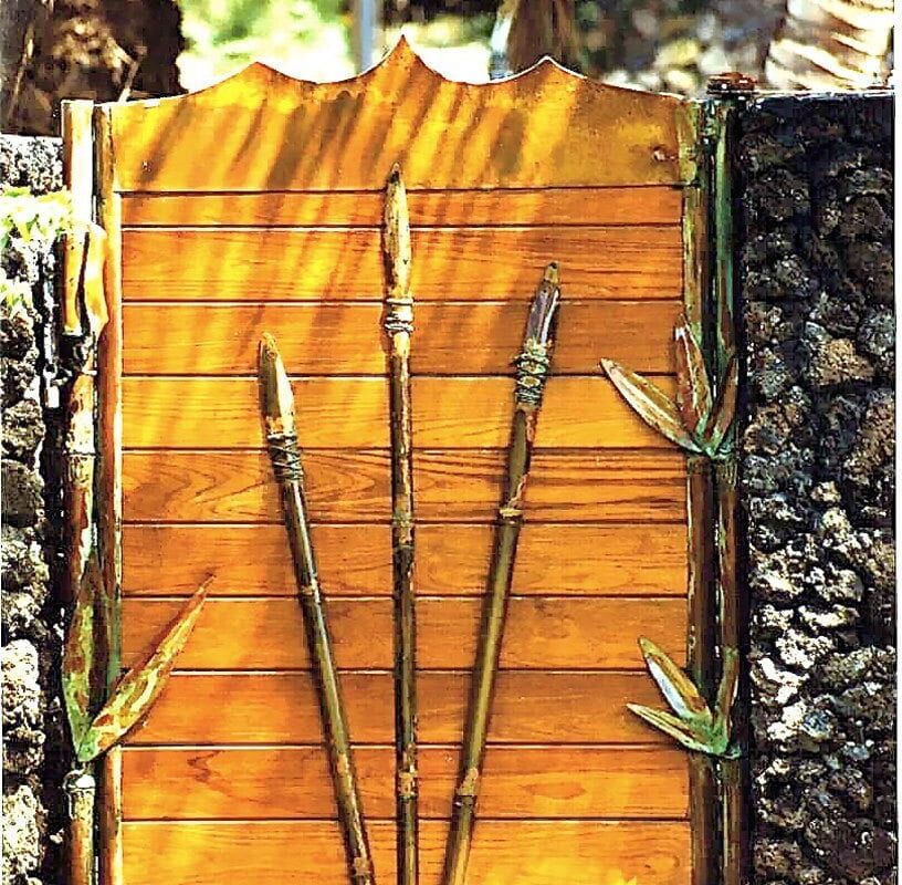 Wooden display board with four bamboo sticks attached.