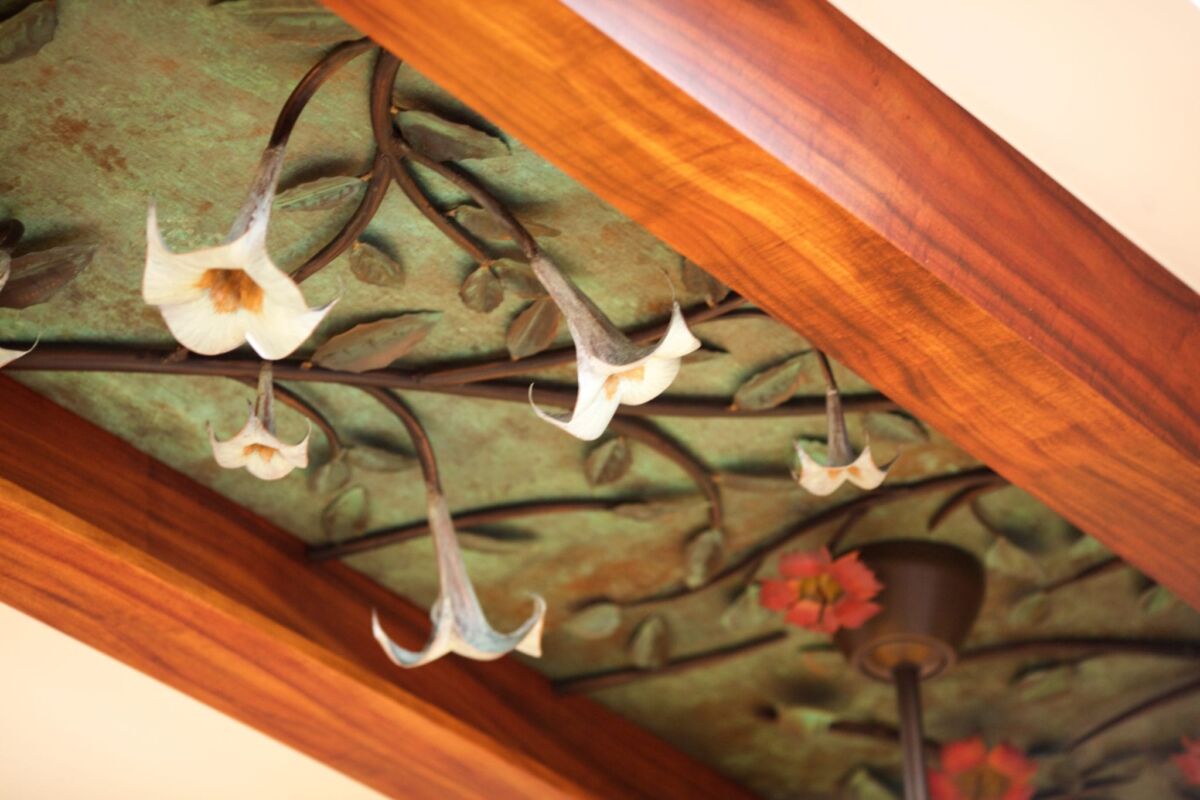 Decorative glass panel with floral and bird motifs framed in wood.