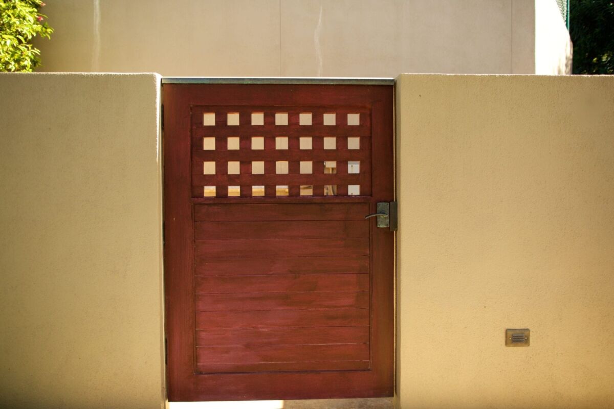 Wooden door with small square ventilation openings at the top.