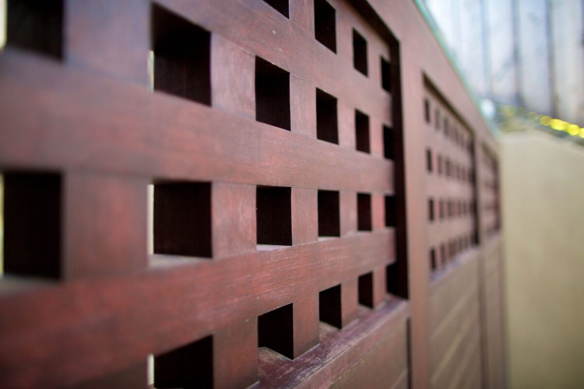 Close-up of a wooden surface with square cut-outs.