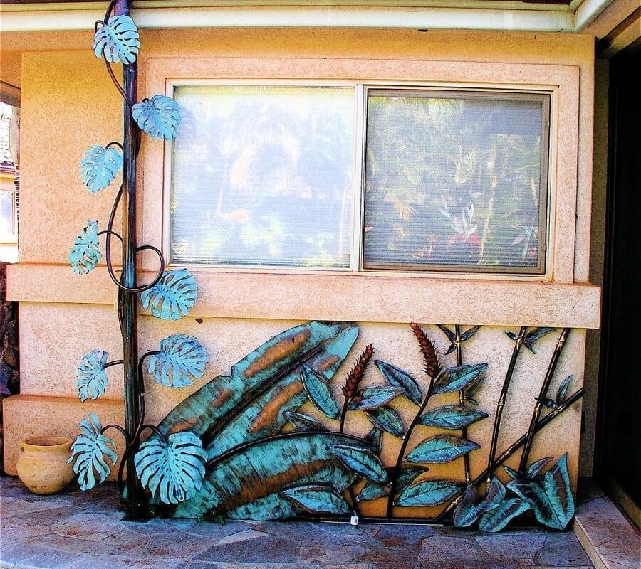 Decorative window with painted logs and leaves on a wooden wall.