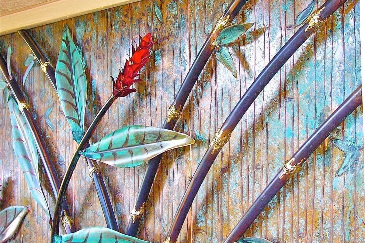 Artistic feather-shaped paintbrushes arranged on a wooden surface.