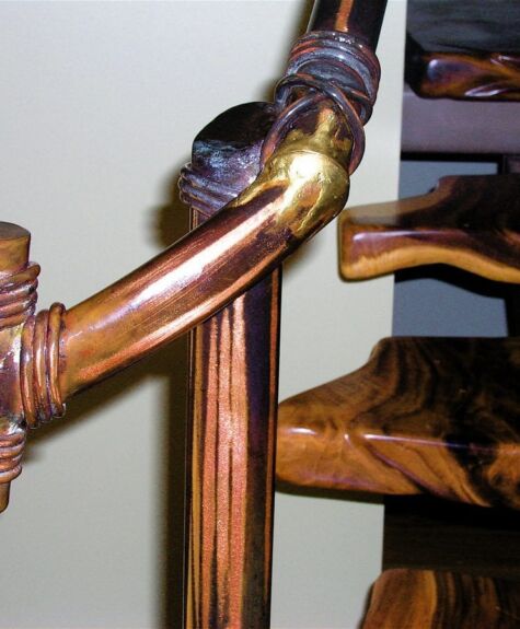 Close-up of a wooden staircase railing with intricate craftsmanship.