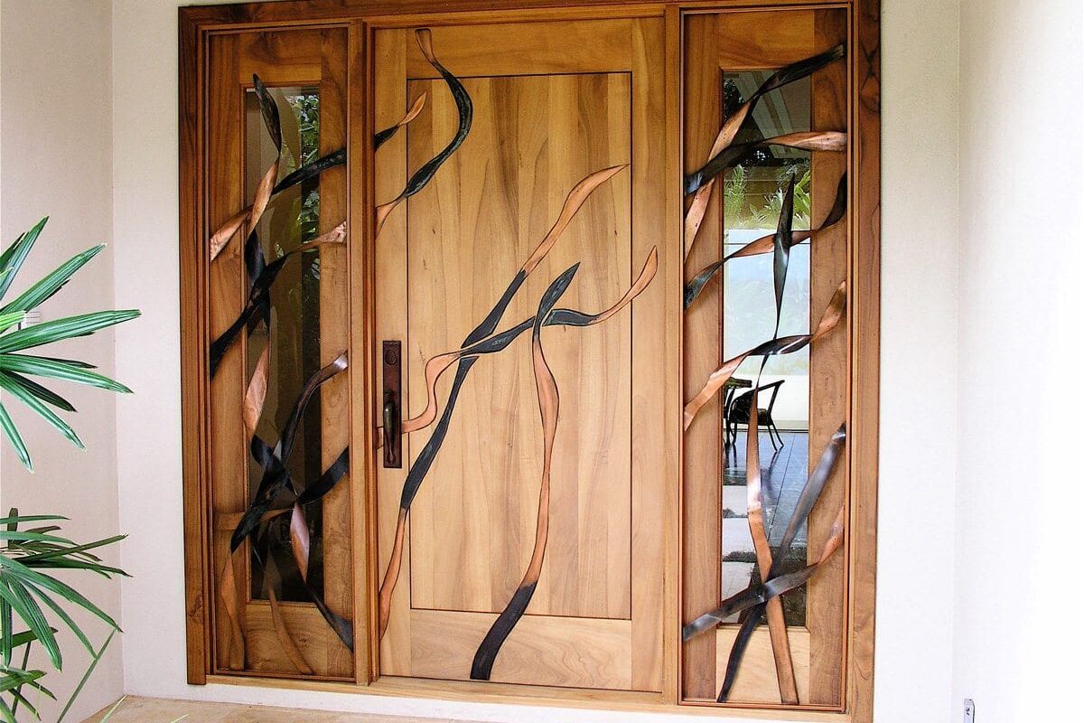 Wooden window with decorative metal tree branch design.