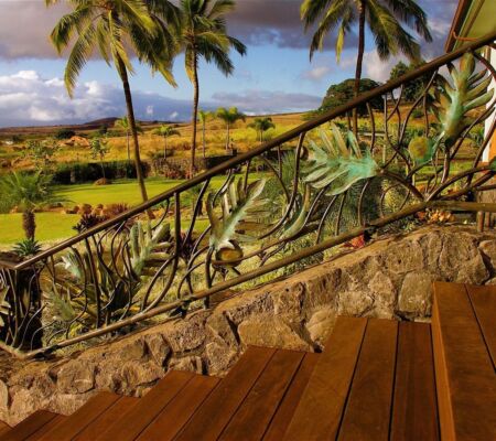 Tropical patio with wooden floor and palm trees in the background.