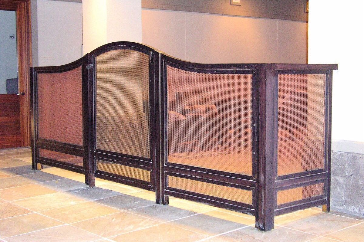 Wooden and mesh room divider panels in a modern indoor space.