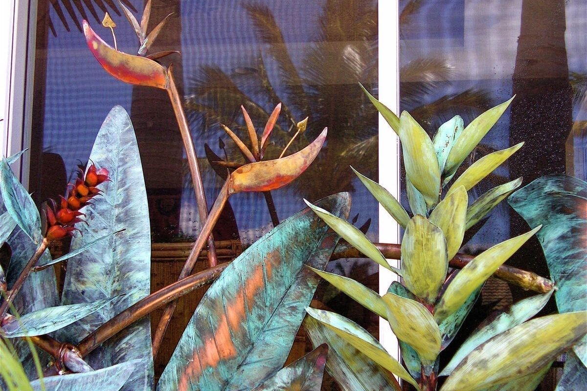 A variety of tropical plants with colorful leaves in a natural setting.