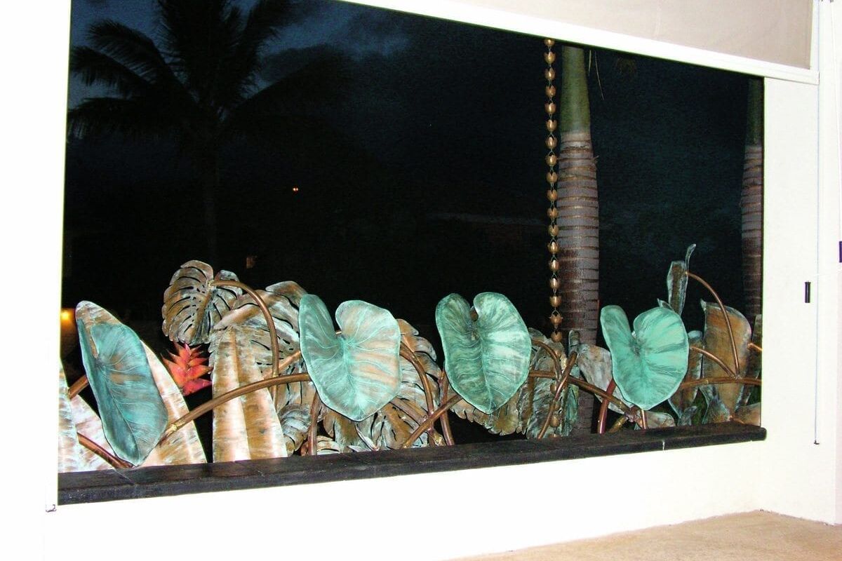 Decorative glass fish figurines displayed on a shelf under soft lighting.