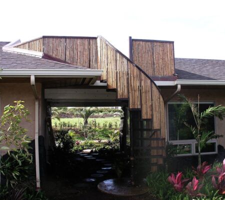Wooden stairway leading to a rooftop deck on a house.