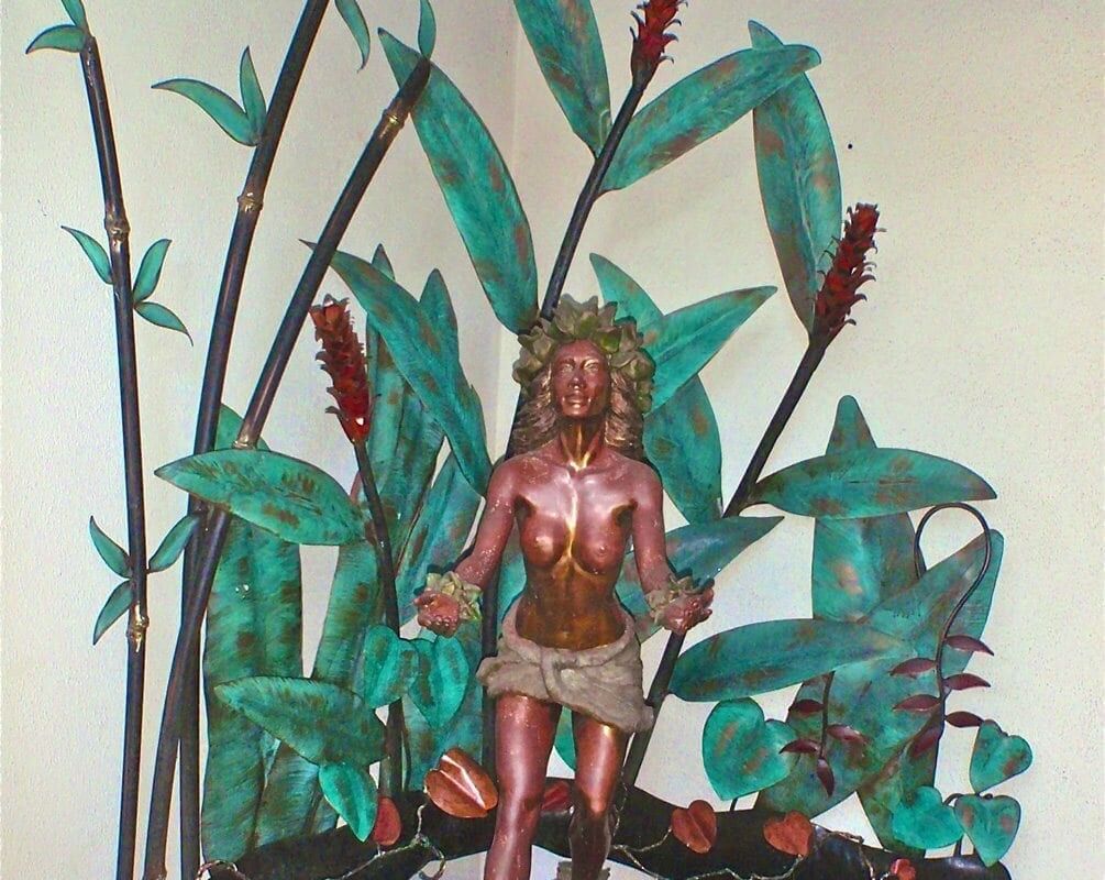 A detailed miniature jungle scene with a tribal warrior figurine.