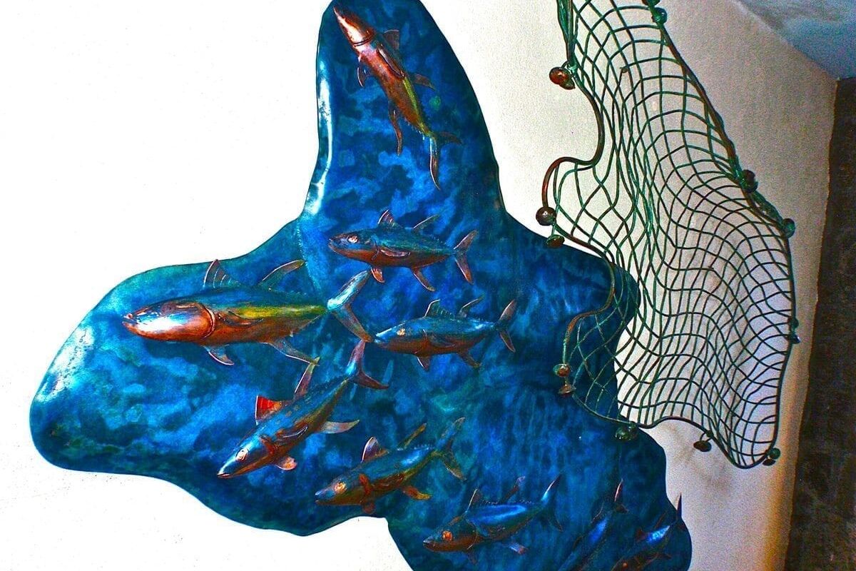 Blue butterfly-shaped glass wall decoration with intricate details.
