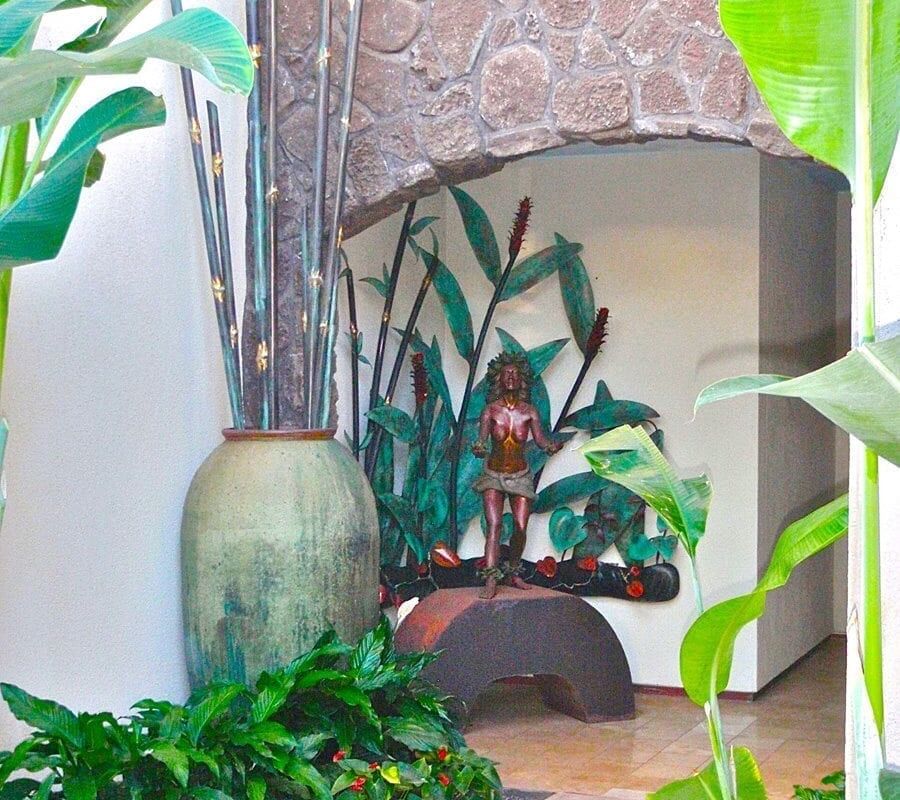 Indoor garden with lush plants and decorative vases in a cozy corner.
