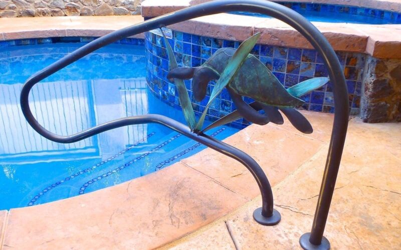 A person diving into a pool, captured mid-air under water.