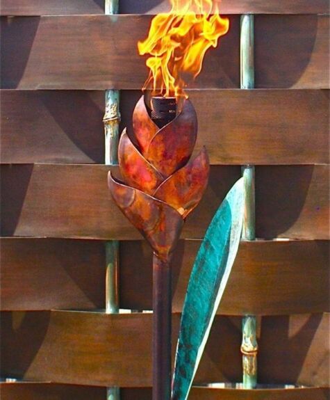 A torch shaped like a flaming flower mounted on a wall.