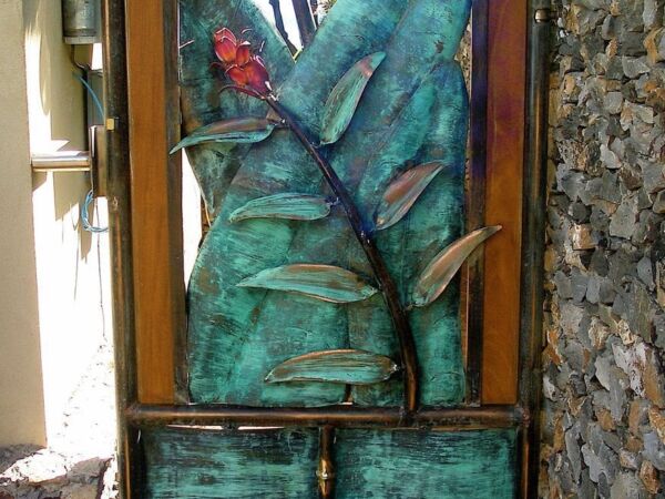 A rustic wooden cabinet with drawers and a large decorative leaf sculpture on top.
