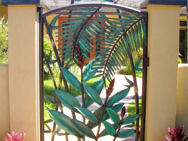 Decorative metal gate with leaf and palm designs.