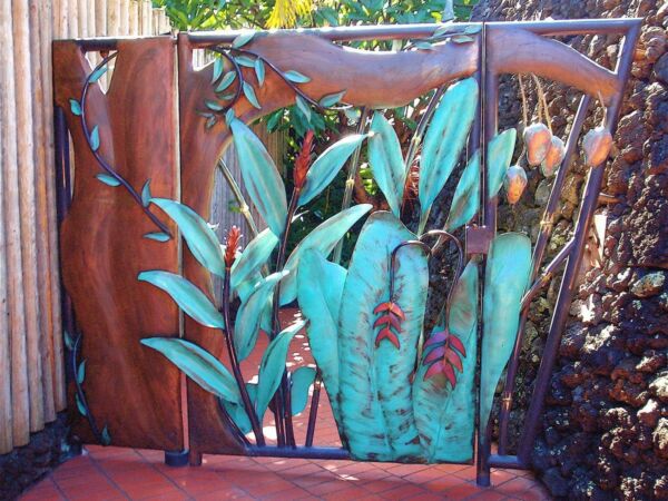 Decorative metal gate with leaf designs and rust accents.