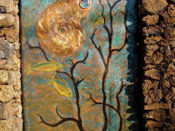A rustic wall with a tree mural and a golden rose.
