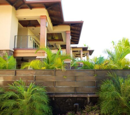 Balcony with ceiling fans and palm hedge