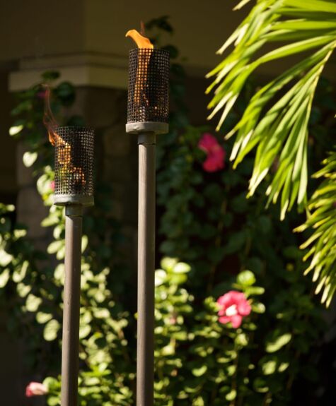 A traditional sword with an ornate handle displayed outdoors.