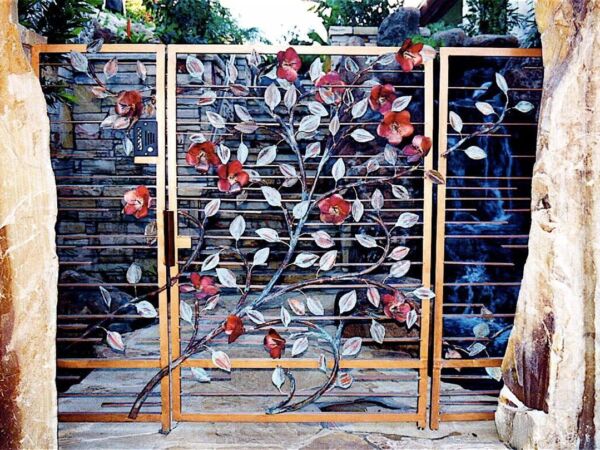 Decorative metal gate with intricate floral design and colorful accents.