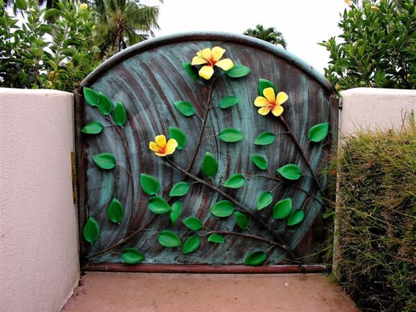 Decorative garden gate with vibrant yellow flowers and green leaves.