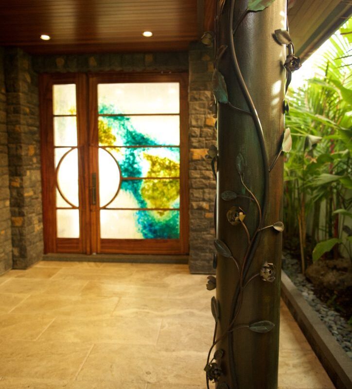 Elegant entrance with stained glass doors and natural stone walls.