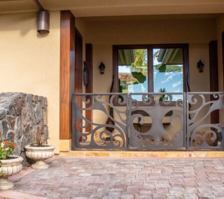 Decorative wrought iron gate at a cozy home entrance.