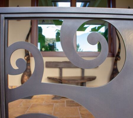 Close-up of a decorative metal railing with spiral designs.
