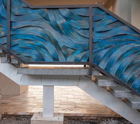 Blue wave mural painted on stairwell walls.