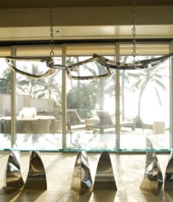 Modern indoor seating with large windows overlooking an outdoor pool area.