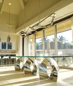 Modern room with large windows and shiny metallic chairs.