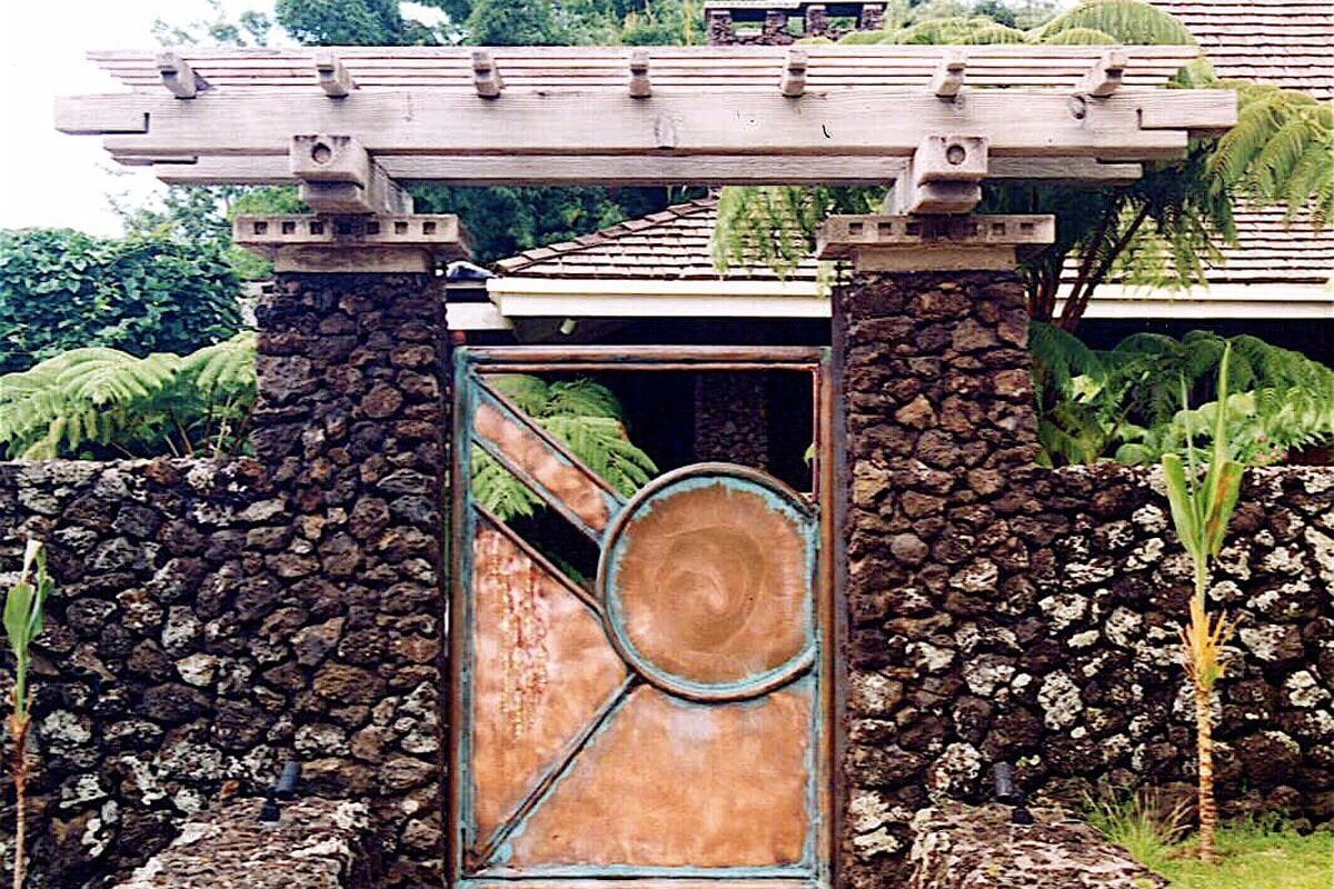 A stone and metal gate with a circular design in the center.